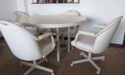 Beige 5 piece dinette set in great condition. $350 or if you're at all interested make me an offer. Comes with four chairs which have no rips or tears in the lining. All chairs wheel and lean back. Table has no scratches except for two small chips on the