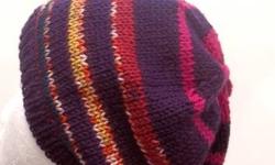 This hand knit beanie colors are the shades of purple, pink yellow, white, lavender and more. The beanie beret is a blend of acrylic and wool yarn. Very stretchy, will fit any head, will stretch out to 31 inches around. The measurements are laying flat on