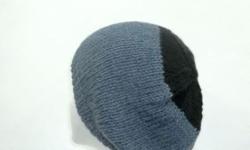 This hand knitted beanie is knitted with soft wool and acrylic yarns. The colors are denim blue and black. This beanie is a medium thickness, very stretchy, will fit any head, stretches out to 31 inches around. The measurements are lying flat on a table,