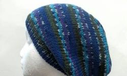 This hand knit slouch hat colors are the shades of purple, lavender ,blue, white and turquoise. The beanie beret is made with a soft acrylic yarn. Very stretchy, will fit any head, will stretch out to 31 inches around.
Available at:
