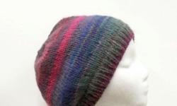 The colors in this colorful knitted beanie hat are lavender, purple, green, bright pink, orange, and more, a large variety of colors. Very stretchy, will fit any head, stretches out to 31 inches around. Very colorful. This soft yarn is 53% wool and 47%