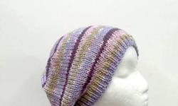 The colors in this knitted beanie are lilac pink, soft green, purple, white. The beanie beret is made with a soft acrylic yarn. Very stretchy, will fit any head, will stretch out to 31 inches around.Available at: http://www.CaboDesigns.etsy.com