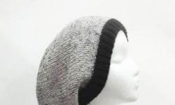 This knitted slouch hat is medium gray with tiny flecks of black and light brown worked into the yarn. Completely hand knitted with a black brim. Suitable for men and women. A warm slouchy beanie hat. Will fit any head, stretches out to 31 inches around.