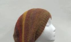 Women's slouchy beanie in beautiful colors of autumn. Comfortable, soft hat,The colors in this hand knitted hat are, colors of golds, sienna, orange, tan brown. Beautiful fall colors. Handmade. Very stretchy, will fit any head, stretches out to 31 inches