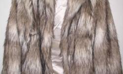 THIS COAT WAS MANUFACTURED BY H & E IN CHINA AND OF ALL MAN MADE MATERIALS. THIS IS A LADIES SIZE 10 AND HAS ABOUT A 2" PILE TO THE FUR WITH BLACK TIPPING. THIS WAS REALLY NICE AND WARM. (NICE TO CUDDLE IN)