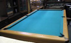 This a large pool table in very good condition. Some light wear on the felt but in all around good condition with automatic ball return. Unknown manufacturer name. Comes with cue sticks, stick rack and the balls. This only offered for local pick-up in