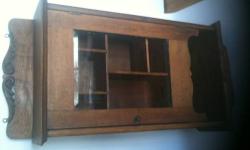 Original Larkin Oak Medicine/Wall Cabinet -
This cabinet is solid oak, with a beveled glass inset in the door, interior shelving, and a pivoting "secret" compartment at the bottom. It has the original metal brackets for hanging. The glass was affixed with