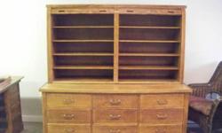 Fabulous Solid Oak Cabinet with 2 piece construction measuring 65" wide x 66" high. TOP cabinet has 10 shelves behind 2 roll top closures measuring 38" high x 18" deep. BASE cabinet has 9 drawers, 27" deep. Base measures 28" high x 30" deep. Would be