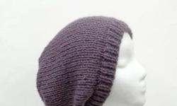 A soft lavender purple called dusty purple is the color of this oversized beanie hat. Worn by men and women. The slouch hat is made with a soft acrylic yarn.Hand wash cool water. Very stretchy, will fit any head, stretches out to 31 inches around. The