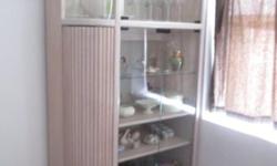LIGHTED CORNER CURIO - Blush colored wood, corner curio cabinet has a side door for storage (great for CDs), bottom double door cabinet, double glass doors with 4 shelves and top section with double glass doors with interior light.
Dimensions: Height - 78