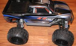 Like New Traxxas Stampede Brushless Warerproof 4x4 VXL RTR 6708. Black and Blue Body, Upgraded to Larger Tires, Upgraded Aluminum Arms in Front, Battery and Charger.