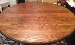 48" oak split base table with 4 - 12" leaves, opens to 98". 6 chairs, good condition. Early 1900's.