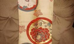This item is gold, gray, and burgundy with an Asian motif. It can be used as a scarf or as a decorative fabric or for other creative purposes. It is 36 by 12 inches.
The first four pictures show the front of the scarf and the last picture shows the back