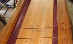 For Sale is a custom built, log edge shuffle board table. It has a 10 ft. playing field. The total length of the table is 140.5" long, 30" wide and 33" tall. This table is from a company out of Palatine Bridge NY. It was previously used in a game room for