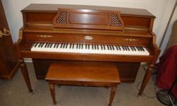 This Lowrey is an elegant console piano. The Lowrey brand is traditionally known as a top quality organ-maker. All Lowrey pianos are 42 inches in height. With features like a grand piano top, lead weighted keys, brass accents and Swedish steel strings,