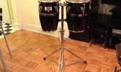 Black / Chrome with Free Stand. This small but vocal conga set includes one 8" and one 9" diameter conga and a height adjustable stand with double braced legs. They have a sound that is a cross between a bata drum, bongos and congas. MINT CONDITION.