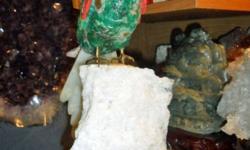 Natural Mineral Rock Gemstone Macaw Parrot Bird Carving. This handmade macaw was carved from hard-type rocks. The bird carvings are hand carved and come from South America. The beautiful macaw stands on a calcite perch. The body was carved from