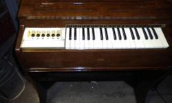 This is a Magnus Organ Model 545 made in New Jersey. It is a vintage
upright version which are rare. The outside finish is worn however the inside mechanisim is clean and all the keys play. It is a stand alone model which is rare.
