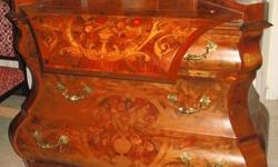 This auction is for a beautiful secretary, called a Marquessa, top drops down, curvy lines, inlaid wood, clawed feet, brass hardware, immaculate condition, three large drawers in the chest, I do not know who the maker is or if it is marked (could not find