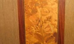 MARQUETRY FLORAL PLAQUE. Beautiful picture made of thin pieces of various color inlaid woods. Double border with subtle flower motif. 14" long and 6 1/2" wide $30
MARQUETRY CITYSCAPE. Various inlaid wood pieces depict a town with a bridge in the