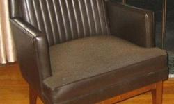 This is an exceptional lounge chair with a great mid-century design. Manufactured by Patrician Furniture Company. Original brown upholstery. Solid walnut base. Original stained finish. Manufacturer's label intact on the bottom side of the chair. Would