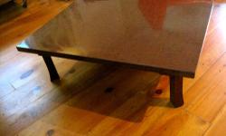 This is a vintage Saarinen style tulip dining table. It has a laminate, woodgrain top with black edges. The table is obviously not in mint condition, please note the scratches in the photo. The metal base is also showing its age. (This could probably be
