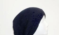 A hand knited navy blue slouch hat,. This slouch hat made with an acrylic yarn. Medium thickness, very stretchy, will fit any head, stretches out to 31 inches around. . Completely hand knitted. Worn by men and women. The measurements are lying flat on a