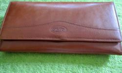 Glory woman's clutch-style, all-leather wallet, has 8 credit card slots, a large change purse, zippered interior compartment and bill slot, envelope slot on back, approximately 7 1/2" wide and 4 1/4" high
