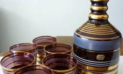 . Czechoslovakian Bohemian Art purple glass with gold, ivory and sanded lines pattern, with original stamp. The decanter is 10? tall with the topper, and has a 4.5? diameter. pattern. All glasses and the decanter base are in excellent condition, with no