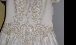 This beautiful soft cream white satin wedding gown has short sleeves, a very long catherdrial train and has intricate pearl and beading on the front and back. The dress is still New condition and has never been worn. The tag is still attached, which cost