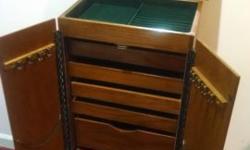 This is a beautiful Oak Jewelry Armoire. It is nearly new. All finishes are in like new condition, all drawers are felt, some with compartments. 6 drawers plus a mirrored top. I do not see any scratches on it.