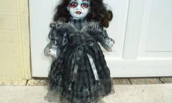 I take porcelain dolls and refurbish them into gothic horror halloween dolls. Except for the base coat and sealer, the dolls detailing has been painted by hand. Her clothing and hair has been stained and she has been sealed. She would be great to add to a