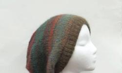 A colorful oversized beanie hat.The colors in this slouch hat are several shades of brown, rust, teal, green, dark orange, a large variety of colors. A colorful oversized beanie. Very comfortable. Will fit any head, stretches out to 31 inches around. The