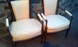 These chairs are in great condition. Very sturdy and comfortable. I believe they're made of walnut. Features upholstered backs, beautifully curved arms, tapered legs, and delicate carvings. Neo-Classical accents. Would work well with your traditional or