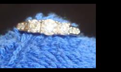 Full carat total -clear cut diamonds. 14k white gold. Approx. size 6 - 7. Excellent condition and barely worn. Cash Only.