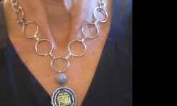 CHAIN RING NECKLACES WITH PENDANTS: These elegant and unusual necklaces are silver color metal, most with 3 flat rings on each side, leading to chain and hook closure, with central ring from which pendant is displayed. Very unique pendants are made of