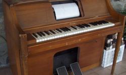 This is a very nice player piano. It works good. The outside has some scratches and dings. There are 84 piano rolls to go with it. I have included a picture and also the right and left side of piano works.. Please email any questions.