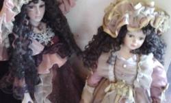 2 tall porcelin dolls-beautiful outfits, long curly hair-excellent condition. $45. each or $75 for both. please call 645-679-4291