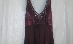 This dress is burgundy color with rhinestones on the front, size 7 , in excellent condition. Price is negotiable. Please e mail [email removed].