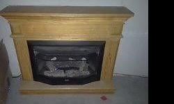 beautiful light oak propane gas fireplace. heats up to 1200 square feet, timer and adjustable heat setting. the fireplace also comes with a space saver piece to attach to the back for those with limited space. also includes logs and screen. fireplace