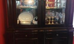 I am selling a 2 year old China closet, its condition is like brand new. No scratches or any imperfections noted to body of the china closet. It has a light to highlight anything you want to be shown on display. Excellent Quality, Belmont Cherry wood and