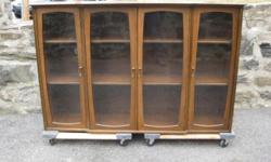 This cabinet was created by Stanley Furniture in the 1960s as part of a breakfront/china cabinet. Beautiful and well constructed. Whose to say its not a bookcase.
Use as is or add legs to make it look like this one: