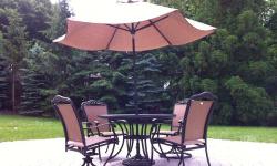 Rustic metal table, four chairs (two swivel chairs) and a large parasol with a stand. Has only been used for six weeks.