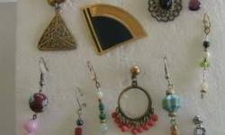 A large group of mostly drop earrings, some button, sprays among them, most with semi-precious stones - lapis, parl, turquoise, rose quartz, peridot, bone, basper, hematite, coral, etc. Some carved wood, rhinestones, crystals, carved bone, mother of