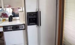 SIDE BY SIDE REFRIGERATOR WITH ICE CUBE MAKE AND COLD WATER IN THE DOOR $ 425.00 NEG MUST PICK UP IN FLUSHING
