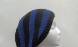 Black with royal blue stripes are the colors of this handmade knitted slouchy hat. Medium thickness, very stretchy, will fit any head, will stretch out to 31 inches around. The measurements are lying flat on a table. Acrylic yarn. Available at: