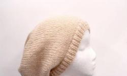 This hand knitted slouchy beanie hat should be a staple in everyone's wardrobe to wear for added style, bad hair days, or just warmth solid beige in color. Very stretchy, will fit any head, stretches out to 31 inches around. The measurements are lying