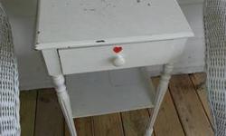 This can be used as an end table or a nightstand. It is a vintage, wooden table that has been painted white. There is one drawer for storage. This table measures 15 inches wide, 14 inches deep and 28 inches tall. It is from a no pet, no smoking home.