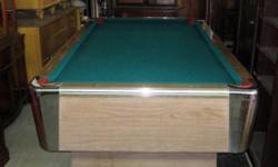 This a small pool table in excellent condition. Hardly any wear on the felt and no scratches of the synthetic mica faces and surfaces. A very well cared for table. With automatic ball return. Made by American Pool Table Company. This only offered for