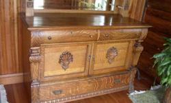Solid oak antique sideboard with decorative carvings around legs and mirror. Excellent condition. No dings, dents, or scratches.